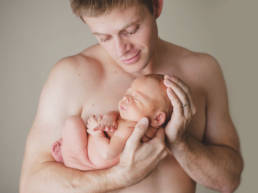 father holding newborn baby