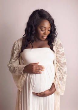 beautiful black pregnant mother photographed posed embracing belly