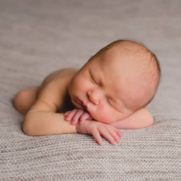 sleeping newborn baby portrait on grey blanket