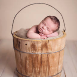 sleeping baby in wooden wash crate